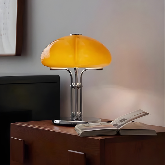 Yellow table lamp on a wooden surface with an open book