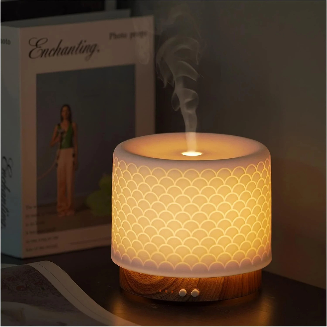 Decorative lamp with scalloped pattern on a table next to a product box.