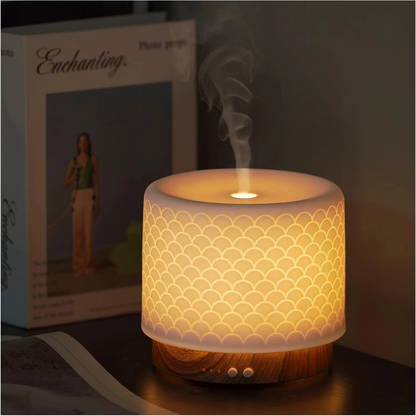 Decorative lamp with scalloped pattern on a table next to a product box.