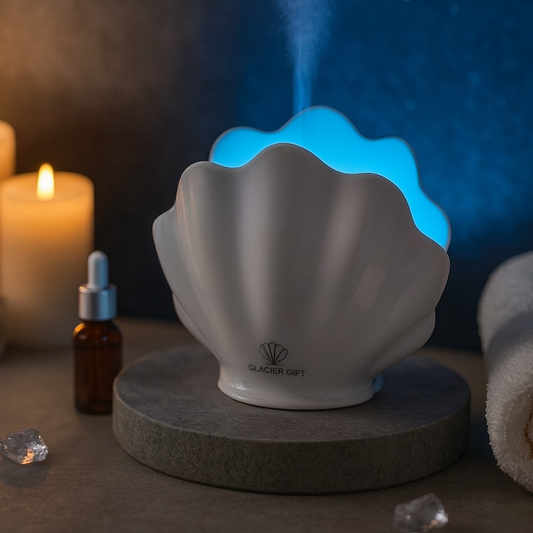 Shell-shaped diffuser emitting mist with a candle and bottle in the background