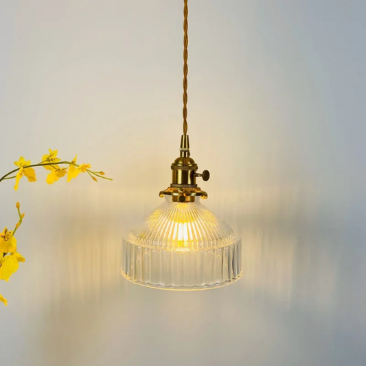 Vintage-style pendant light with ribbed glass shade on a neutral background