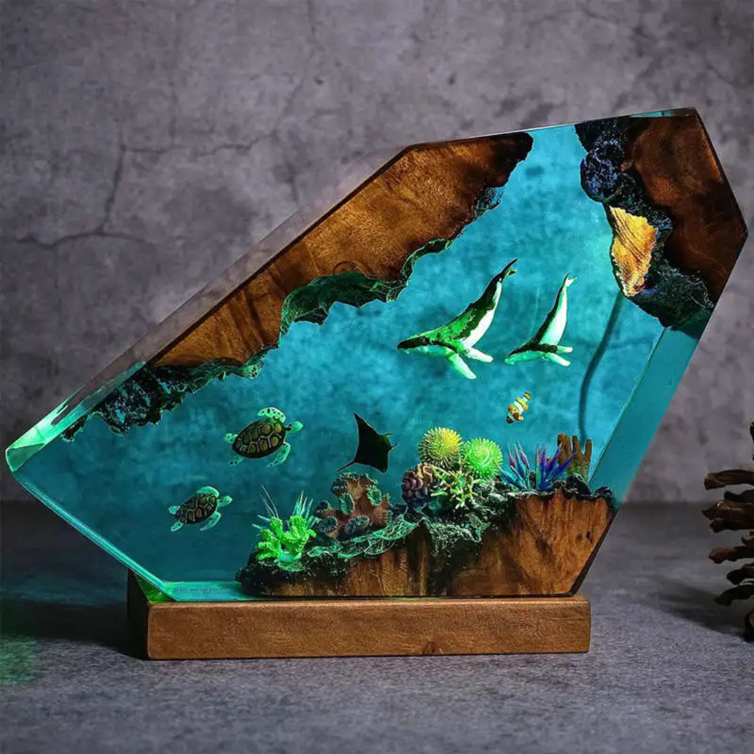 Tabletop aquarium with wooden base and glass cover, featuring fish and plants on a gray background.