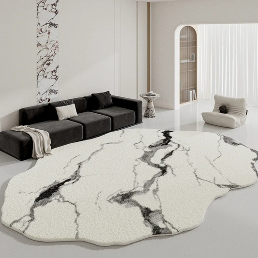 Modern living room with a marble-patterned rug and gray sofa.