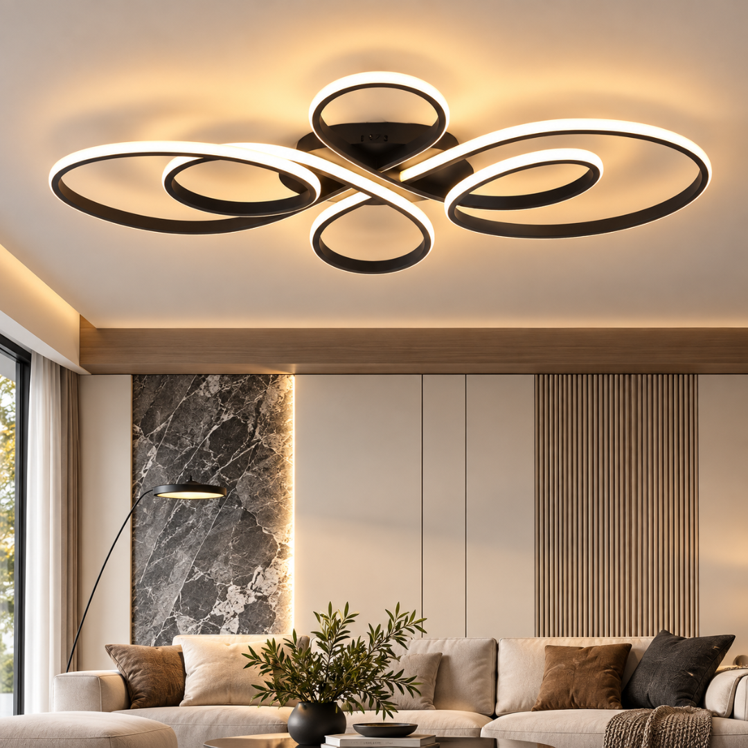 Modern ceiling light fixture with multiple interlocking circular rings in black and white, emitting warm light in a contemporary living room setting.