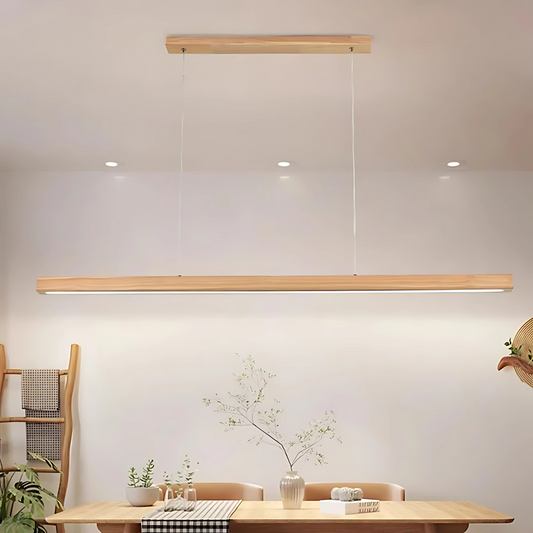 Modern pendant light fixture hanging above a dining table with minimal decor.