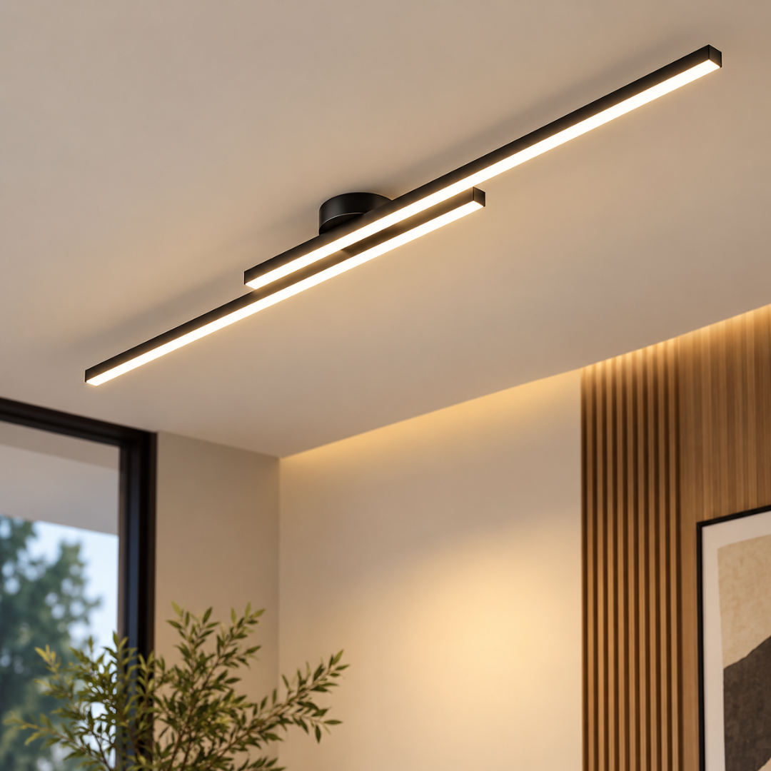 Modern linear ceiling light fixture with a matte black finish and warm white LED illumination, mounted on a ceiling in a contemporary interior setting.