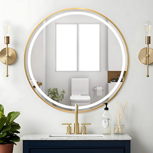Bathroom with round illuminated mirror, gold fixtures, and decorative elements.