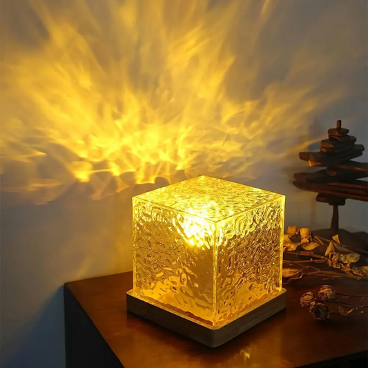 Glass block light emitting a warm glow on a wooden surface with a blurred background