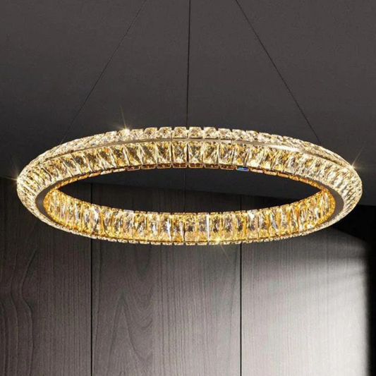 Gold circular chandelier against a dark background