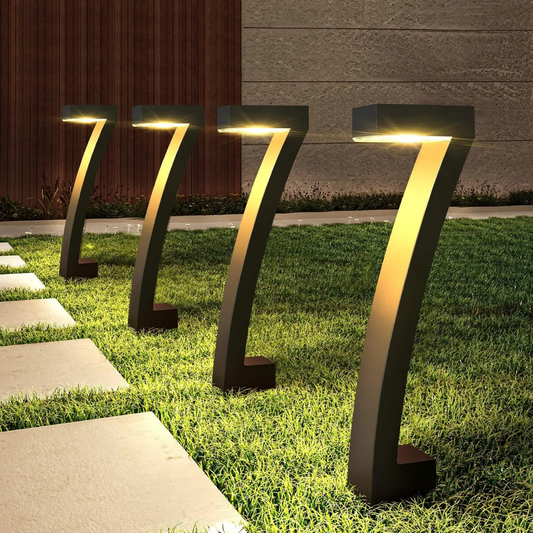 Modern outdoor garden lights on grass with a building in the background