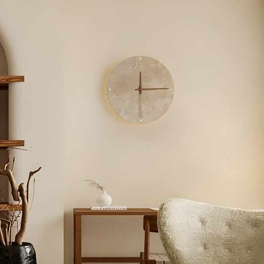 Round wall clock on a beige wall with minimal decor