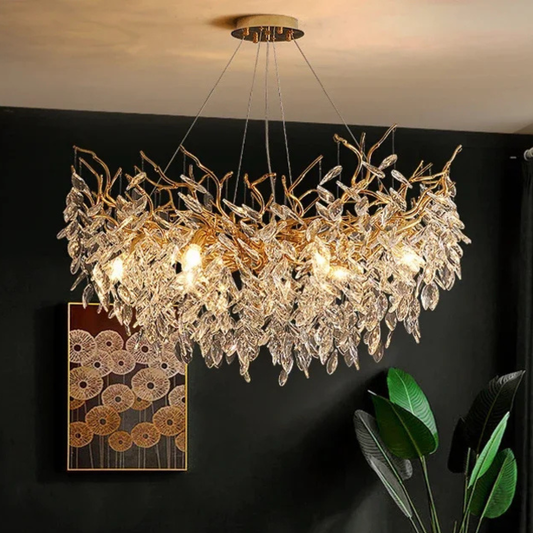 Crystal chandelier hanging in a room with a dark wall and decorative elements.
