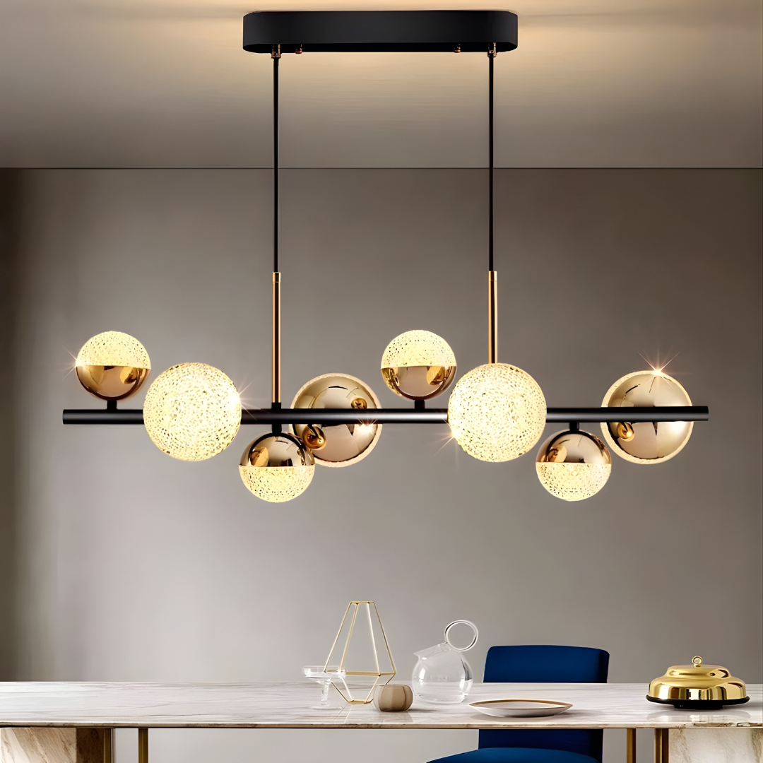 Modern chandelier with gold and black design in a room setting.