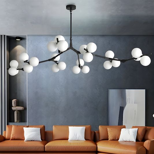 Modern chandelier with white spherical lights in a living room setting.