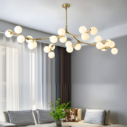 Modern chandelier with gold frame and white bulbs in a living room setting.