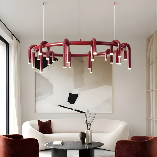 Modern living room with a red chandelier, white sofa, and abstract art.