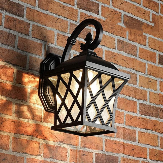 Decorative outdoor wall light fixture on a brick wall